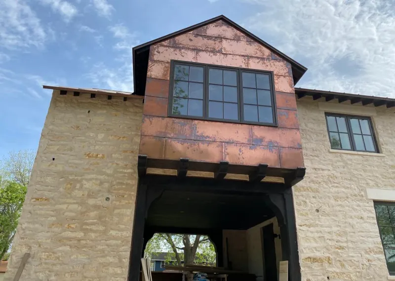 Copper metal panel facade on a stone building for Metal Roof Coating in Le Ray